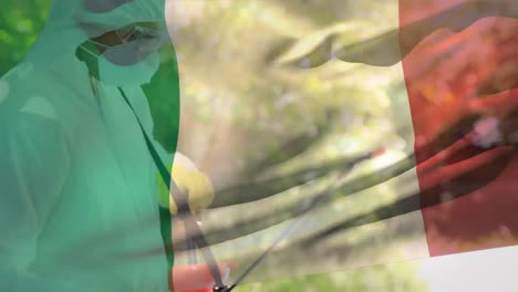 Animation-of-Italian-flag-with-healthcare-worker-in-background-during-coronavirus-pandemic