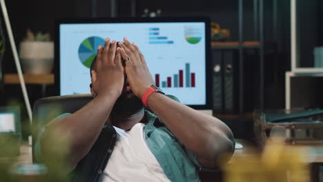 closeup disappointed afro business man looking at diagram in hipster office