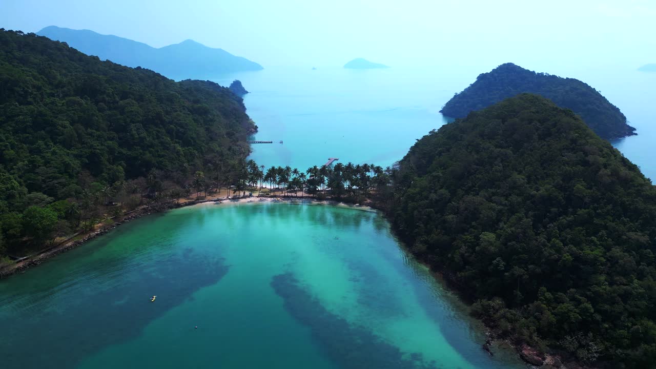 Scenic aerial view of lush green hills and turquoise waters on Koh Chang Ngam Island. Breathtaking aerial view flight drone shot footage from above