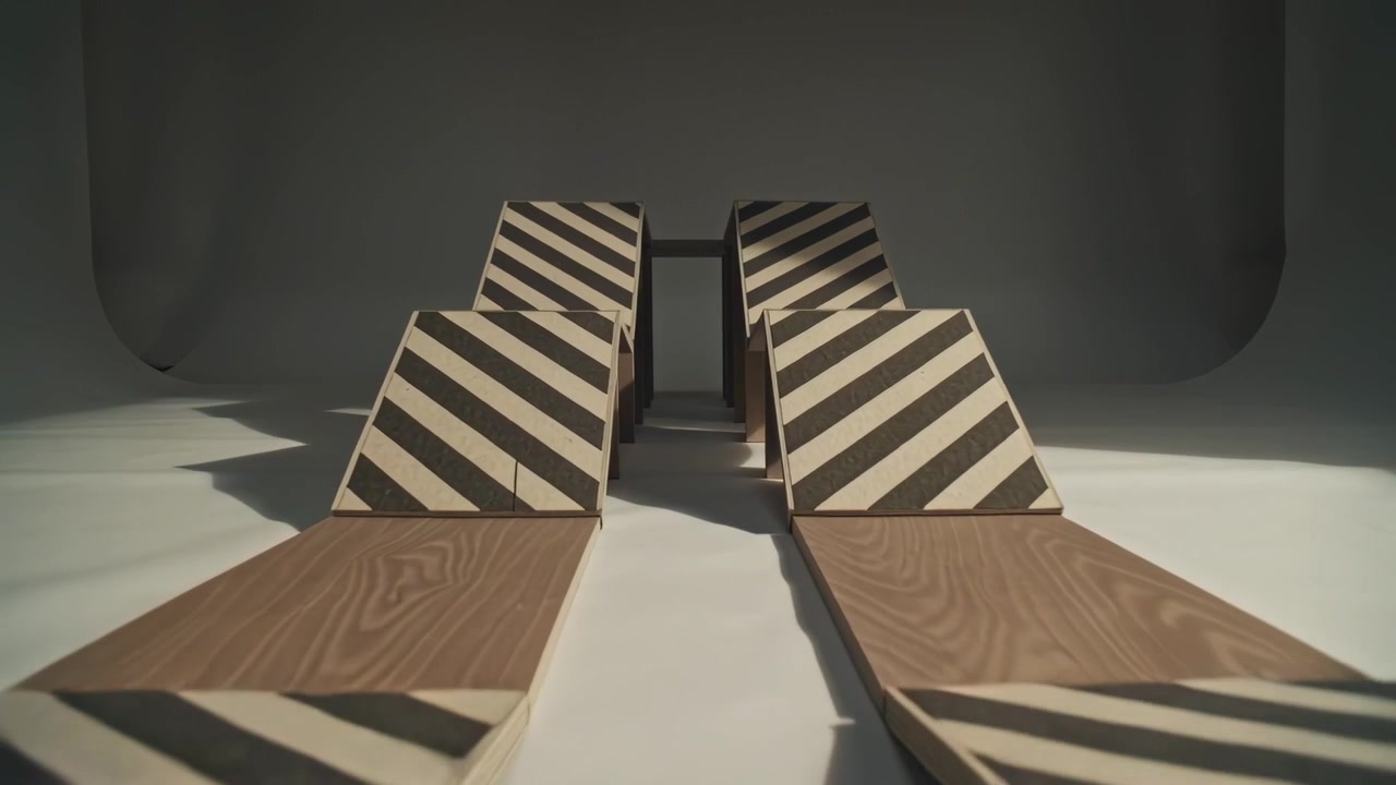 Moving camera showing wooden tracks striped wedge ramps tilting flaps to reveal structure in studio