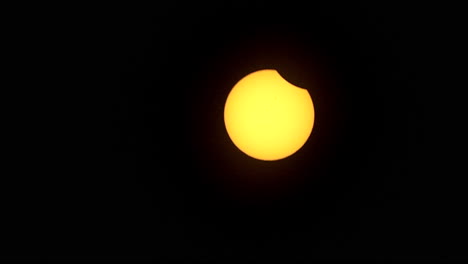 Zoom-out on solar eclipse as partial phase begins
