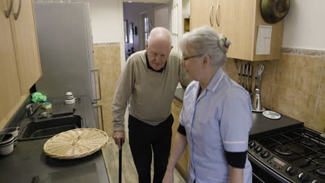 elderly woman doing laundry in the kitchen