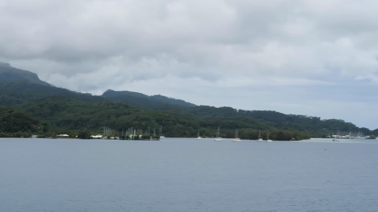 Papeete, Raiatea, Society Islands, French Polynesia. Slow panning of the coastline.
