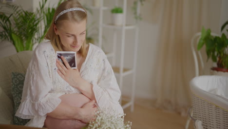pregnant woman holding ultrasound picture