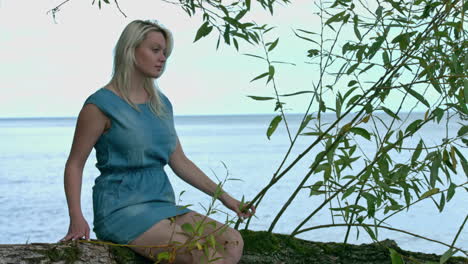 unlucky young girl with dress sitting alone on the beach during holiday and waiting