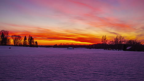 vibrant colorful sky of early morning sunrise in winter rural landscape, fusion time lapse