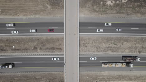 farm bridge over highway crossroads in summer, aerial top down drone view - raw file d-log