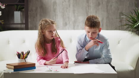 Junior-schoolchildren-do-homework-sitting-in-living-room