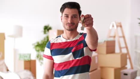 young man holding key ring to his new house