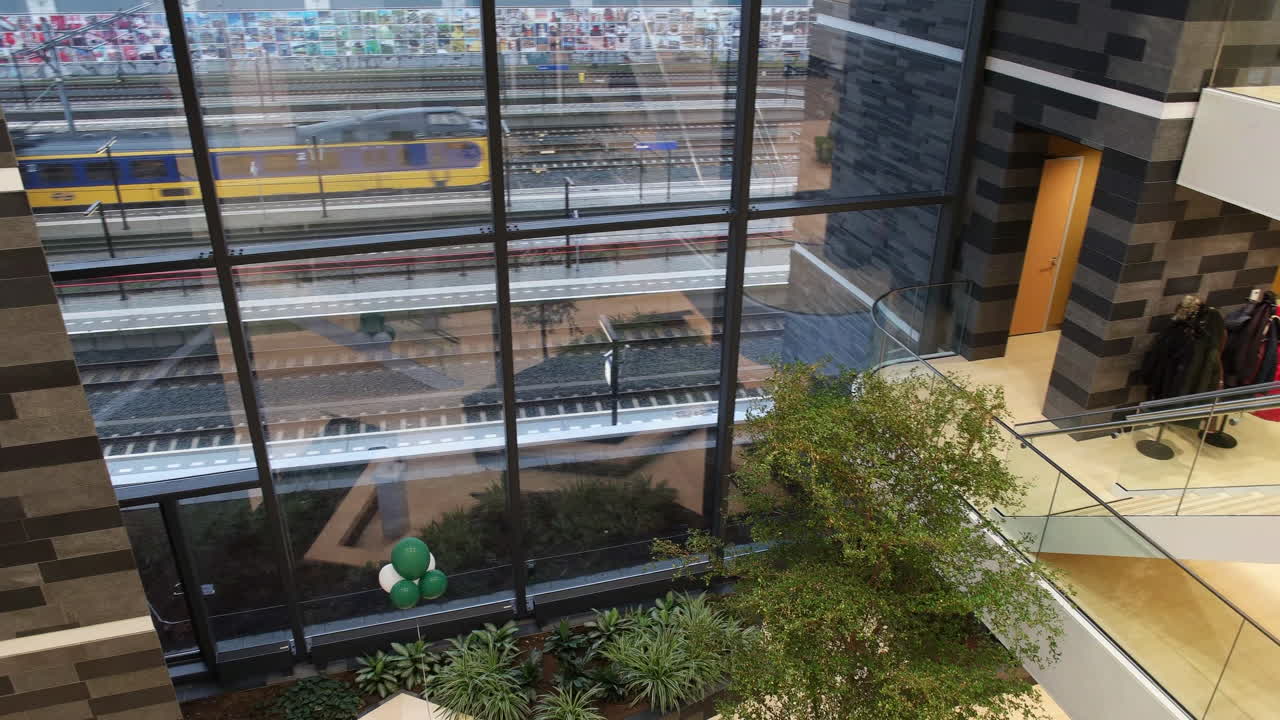 Office Building Of Rabobank, Gouda With Modern Interior Of Glass Wall And Fresh Indoor Garden