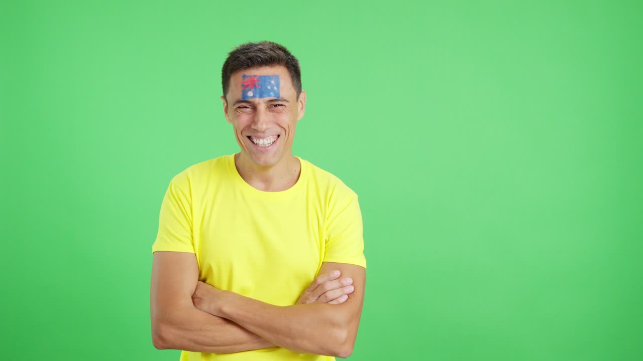 Man standing with australian flag painted on face smiling