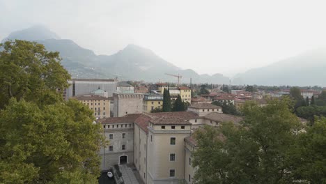 Aerial-View-of-Riva-Del-Garda-Lakeside-City,-Italy,-MAG-Museum-and-Downtown-Area-on-Summer-Morning,-Pedestal-Drone-Shot