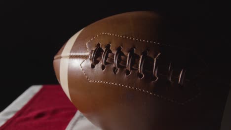 close up studio shot of american football on stars and stripes flag 10