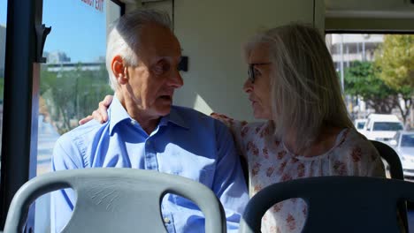 Senior-couple-interacting-with-each-other-while-travelling-in-bus-4k