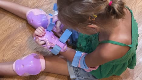 child putting on protective gear for skating or other sport activities