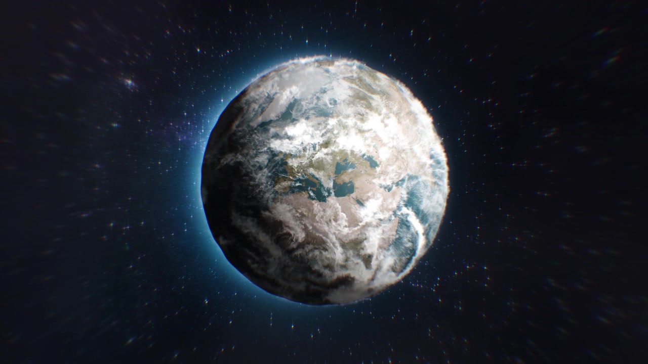 La cámara se acerca a la Tierra y pasa la Luna. Sobre el mundo hay muchas nubes esponjosas y el espacio oscuro está lleno de estrellas.