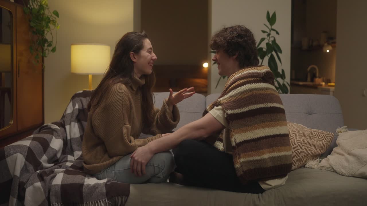 Couple having a conversation on the couch