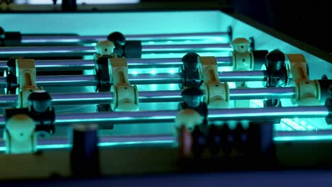 slow pan of an led-backlit foosball table