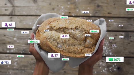 holding freshly baked bread, hands with social media animation icons overlay