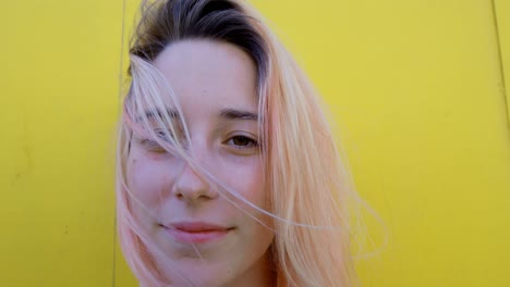 young woman against yellow wall 4k