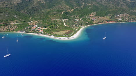 aerial: slow panning drone shot of agios dimitrios beach with amazing and turquoise crystal clear water in alonnisos island, greece