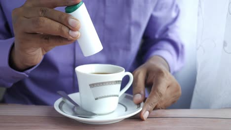 persona que bebe té con azúcar