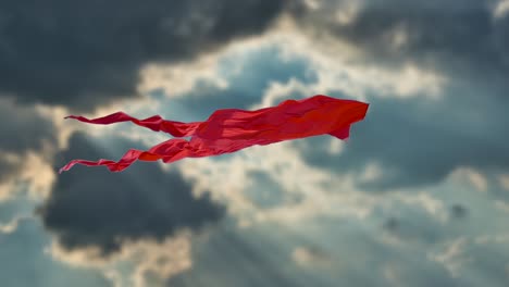 Red-Kite-in-air-swaying-at-winy-day-against-cloudy-sky-at-sunset