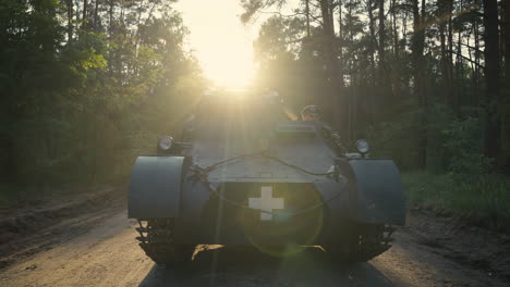 vintage military medical tank in a forest at sunset