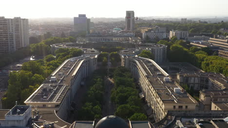 Aerial-back-traveling-over-Antigone-residential-buildings-architectural-sunset