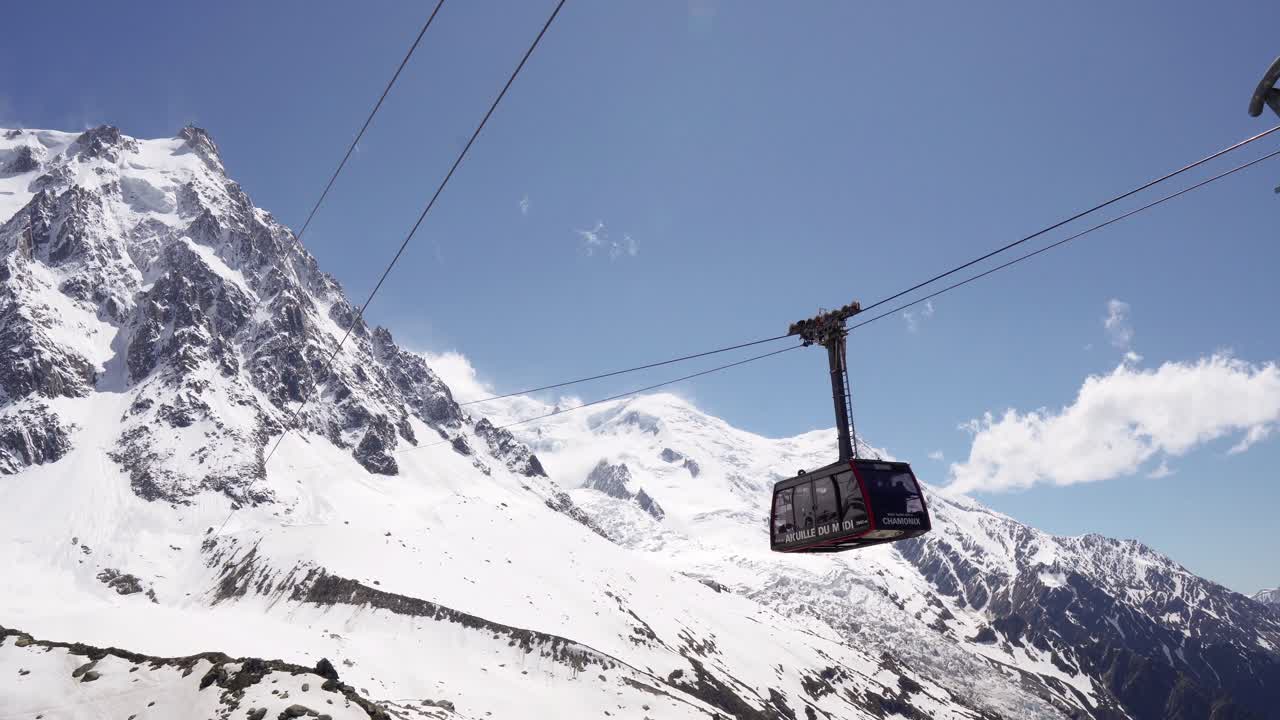AIGUILLE DU MIDI CHAMONIX MONT BLANC, FRANCE on JUNE 2019. Cable car to the snowy mountain aiguille du midi on a clear sunny day. french alps view of mont blanc