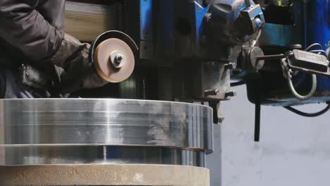 sparks during the cutting of metal by an angle grinder. the worker cuts off the metal corner.