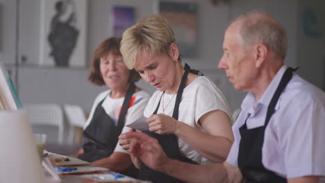 elderly men and women share their impressions of the drawing courses. emotions of a senior people talking together. activities for older friends