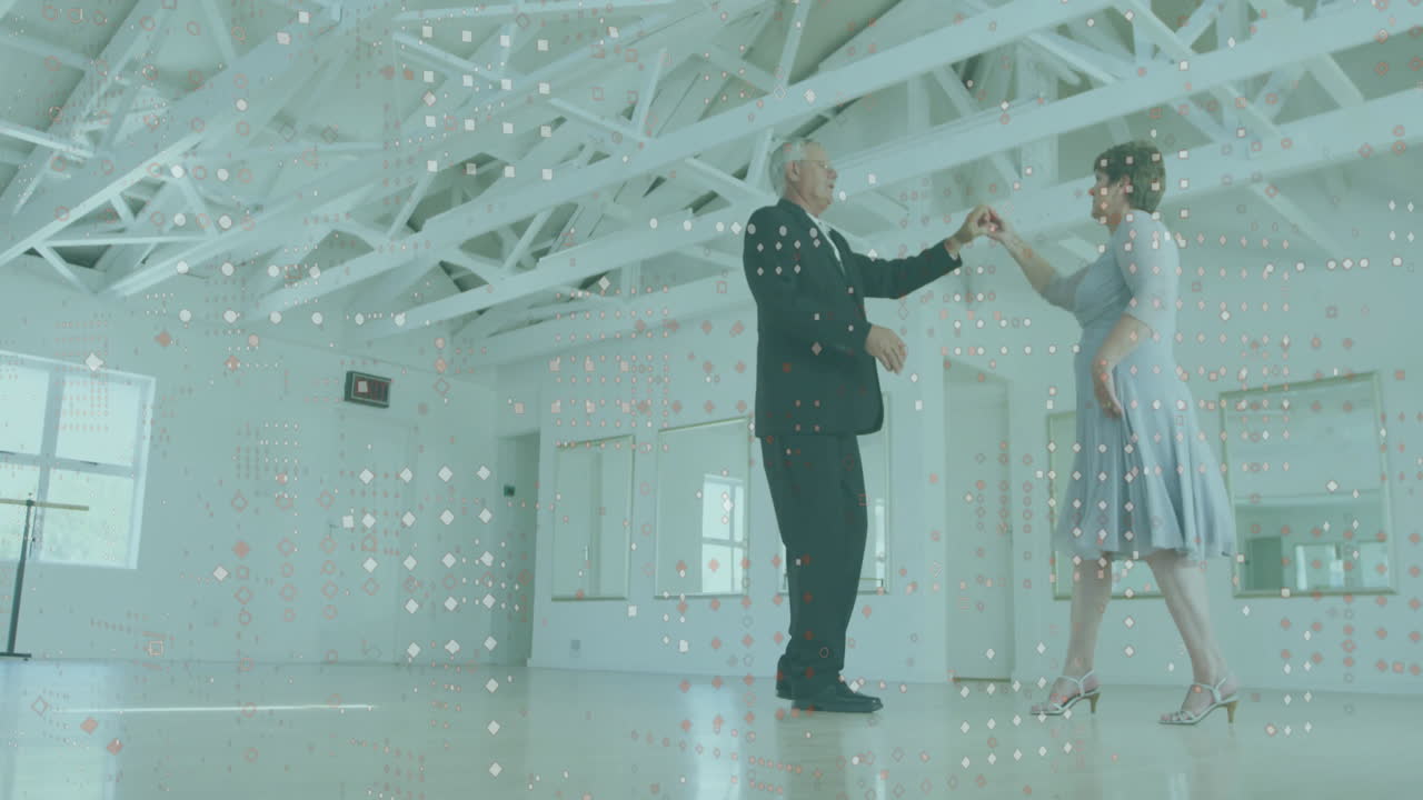 Elderly couple dancing in bright room with digital data animation overlay