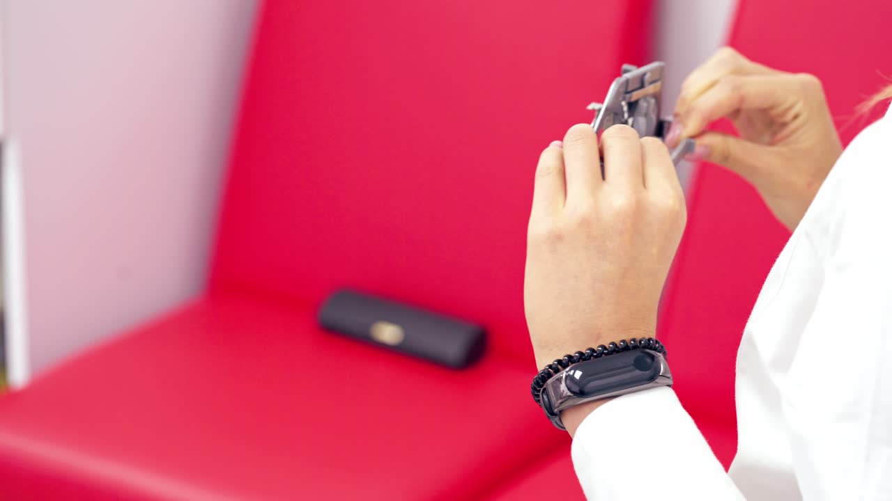 Profile of a young woman taking off testing device for eyes. Selection of spectacle lenses in clinic.