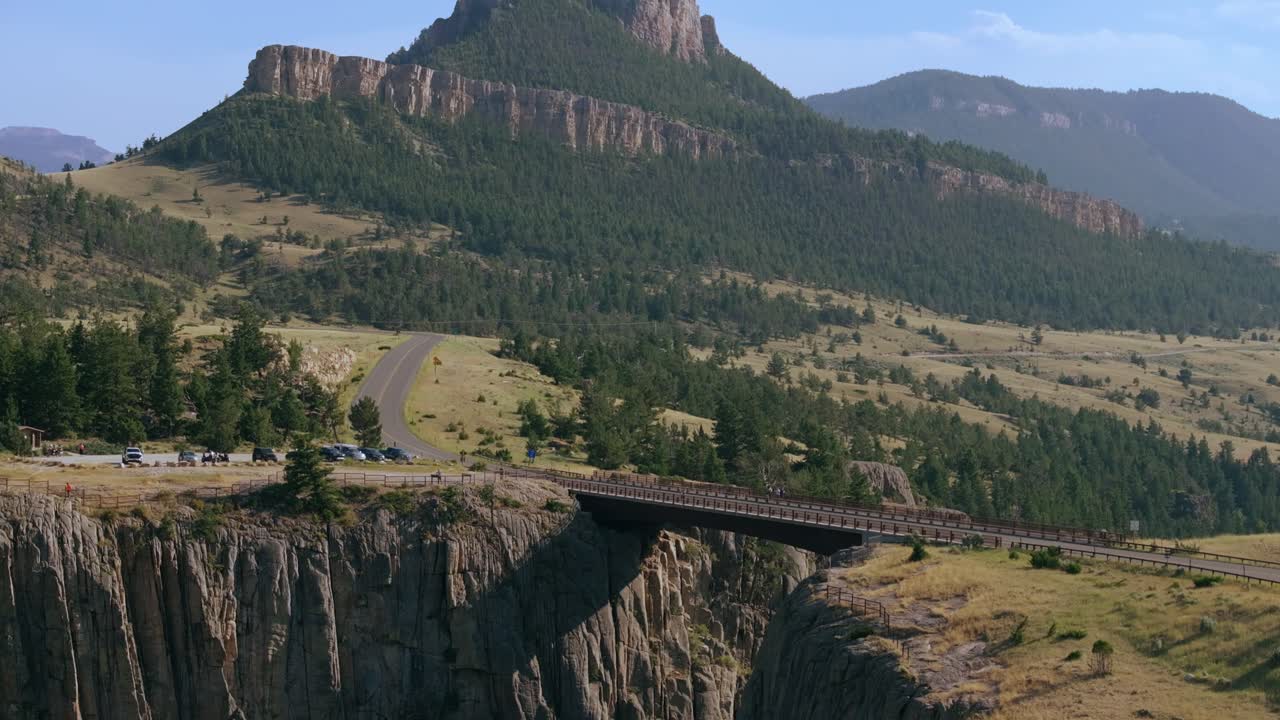 Aerial approach to Sunlight Creek Bridge in Wyoming, capturing the bridge's height and the dramatic drop of the canyon below
