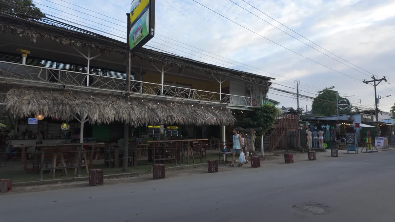 Rustic café with thatched roof in Puerto Viejo, Costa Rica, along a quiet street