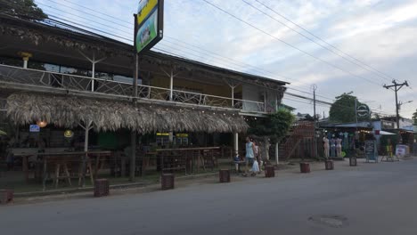 rustic café with thatched roof in puerto viejo, costa rica, along a quiet street