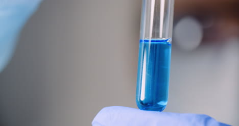 working in laboratory scientist using holding test tubes in hand
