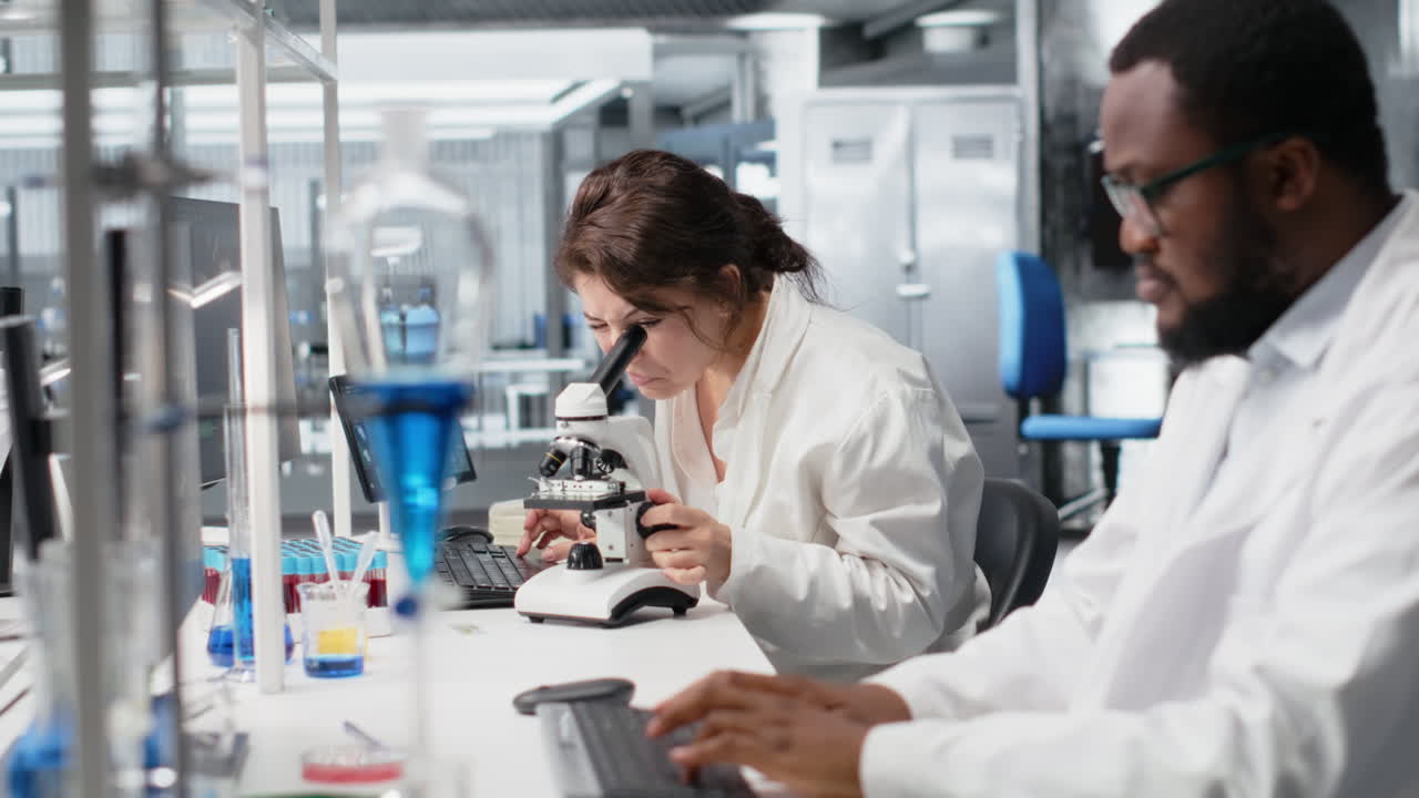 Vertical video Materials scientist operating compound microscope, studying genetic disorders