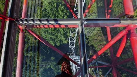 pov shot walking on a glass bridge at the ruyi peak ropeway in yangshuo, china