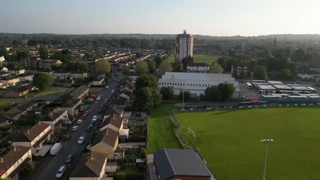 flying over a suburban cityscape, flying towards a skyscraper