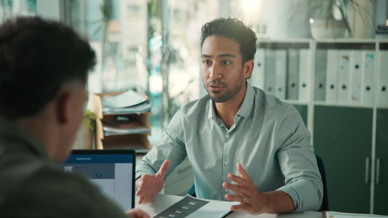 Professional Man Speaking and Gesturing During an Office Meeting