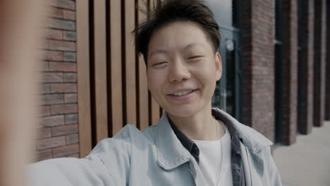 smiling person taking a selfie outdoors
