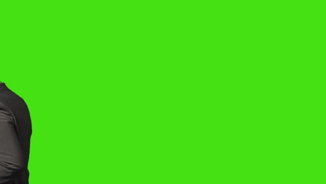 close up of businessman with laptop talking on mobile phone walking across frame against green screen background 2