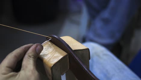 sewing leather with a stitching pony support made to hold the  piece in place