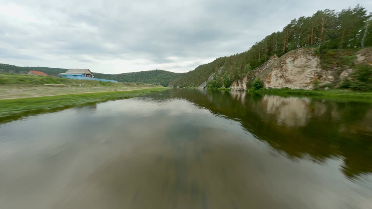Several inflatable boats with holidaymakers on the river on a cloudy day. Direction for travel. Family vacation. The silence and tranquillity of the forest. The sky is covered with clouds.