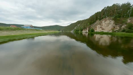 several inflatable boats with holidaymakers on the river on a cloudy day. direction for travel. family vacation. the silence and tranquillity of the forest. the sky is covered with clouds.