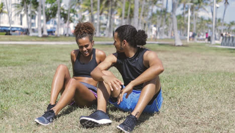 Couple-sitting-and-resting-on-grass