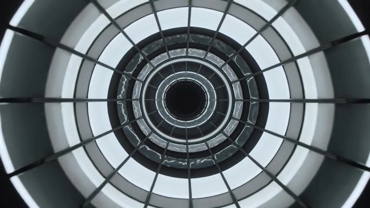 Spingendo la telecamera in avanti creando movimento attraverso un assemblaggio ad anello attorno a un vuoto centrale all'interno di una griglia di condotto.