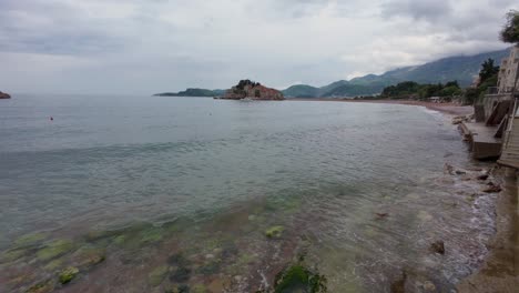 a dramatic coastal view of sveti stefan and stari grad old town in montenegro captured on a rainy day